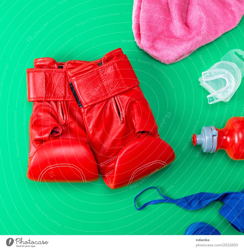 red leather boxing gloves, a plastic water bottle Bottle Lifestyle Fitness Sports Track and Field Leather Gloves Above Blue Green Pink Red Protection Colour
