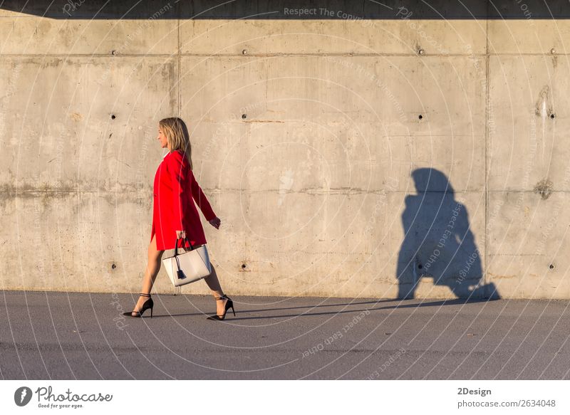 Blonde woman wearing red jacket walking on the street Lifestyle Beautiful Business Feminine Woman Adults Shirt Skirt Jacket Footwear High heels Red Black White