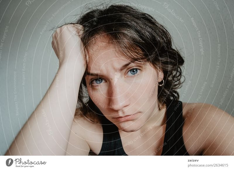 brunette girl with short hair and blue eyes with headache Lifestyle Beautiful Face Illness Human being Woman Adults Youth (Young adults) Hand Brunette Sadness