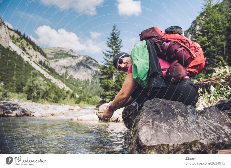 Woman refreshes herself while hiking Vacation & Travel Adventure Hiking Young woman Youth (Young adults) 18 - 30 years Adults Nature Landscape Summer