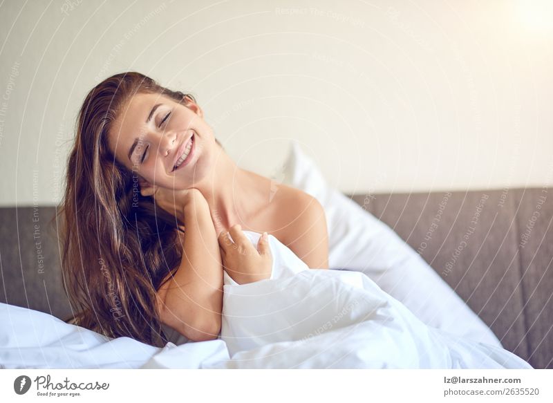 Young woman sitting in bed and smiling Happy Beautiful Relaxation Bedroom Woman Adults 1 Human being 18 - 30 years Youth (Young adults) Brunette Smiling Sleep