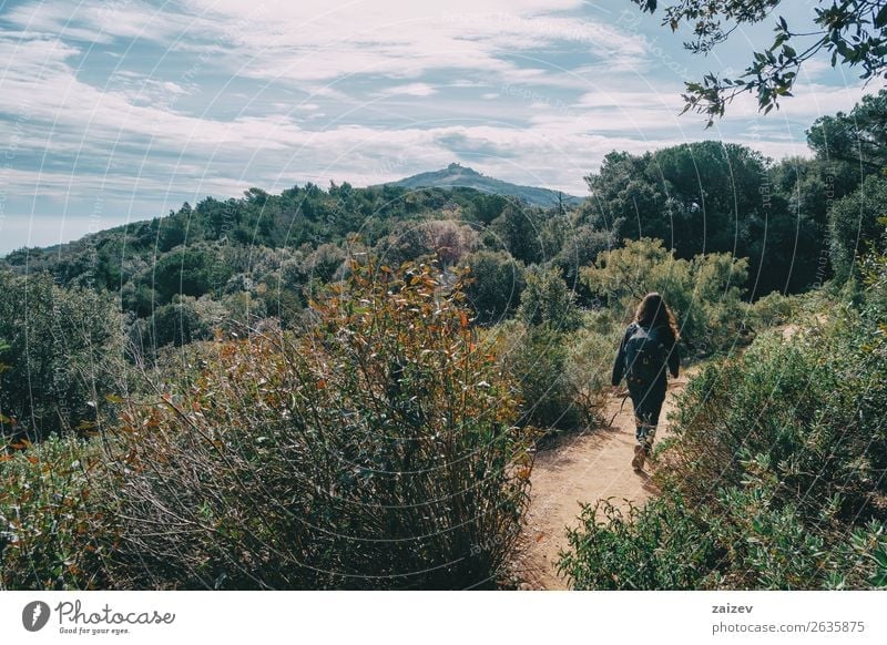 Woman walking in the distance on a trail among mountains on a sunny day Lifestyle Joy Happy Leisure and hobbies Vacation & Travel Tourism Adventure Freedom