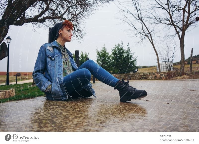 Young redhead woman alone in a village in a rainy day Lifestyle Style Freedom Winter Human being Feminine Androgynous Young woman Youth (Young adults) Woman