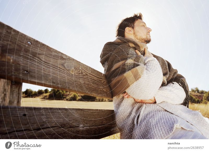 Side face of a young man enjoying the calm morning Lifestyle Happy Face Relaxation Calm Freedom Sunbathing Man Adults Sky Autumn Scarf Wood To enjoy Sit