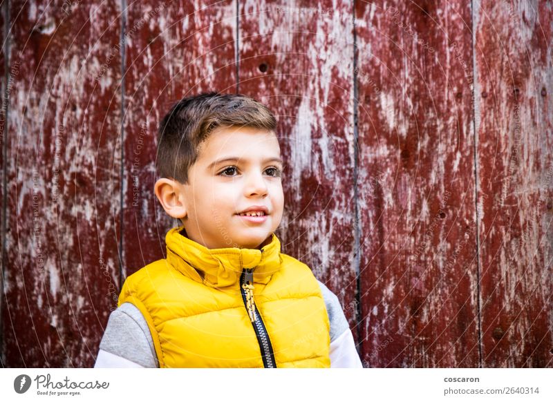 Little kid with a yellow vest in front of an old red door Style Happy Beautiful Face Child Human being Baby Toddler Boy (child) Infancy 1 3 - 8 years Fashion