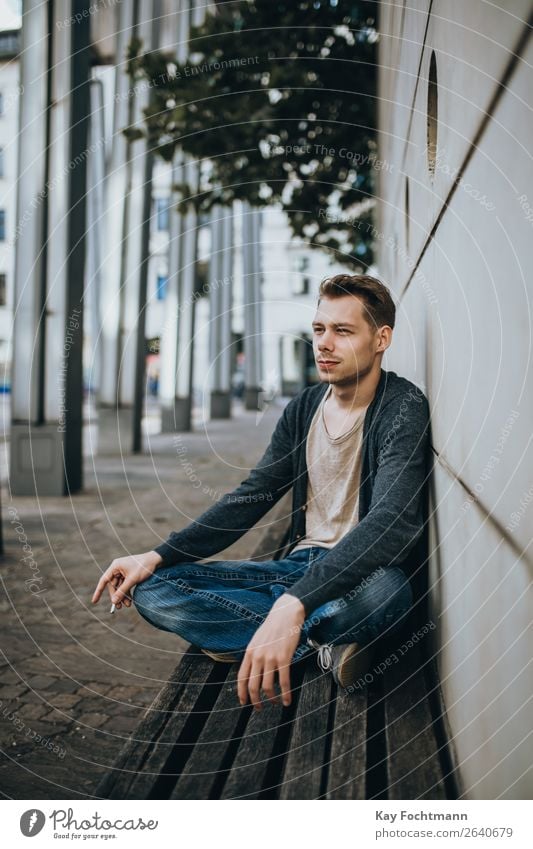 portrait of sitting man on bench addiction adult beard casual caucasian cigarette cool face guy habit handsome health lifestyles look male masculinity outdoors