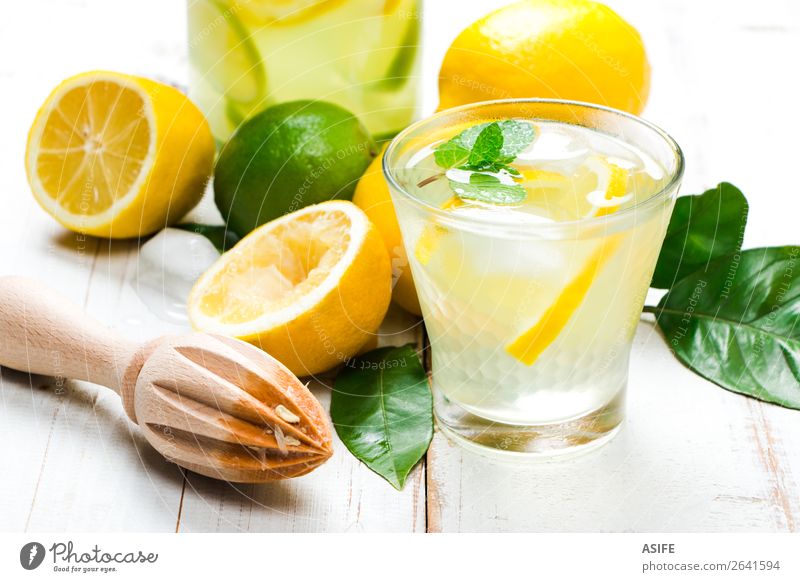 Homemade lemonade with reamer on white wooden table Fruit Diet Beverage Lemonade Juice Summer Table Leaf Wood Cool (slang) Fresh Yellow Green White lime citrus