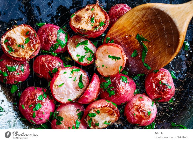 Roasted radishes in a pan Vegetable Nutrition Vegetarian diet Diet Pan Spoon Plant Wood Fresh Small Delicious Red Colour radished roasted Root cooking Wok