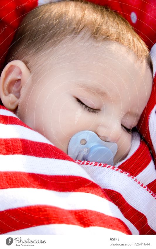 Adorable baby sleeping wrapped in a red blanket Face Life Relaxation Summer Sun Child Human being Baby Boy (child) Infancy Baby carriage Stripe Sleep Dream
