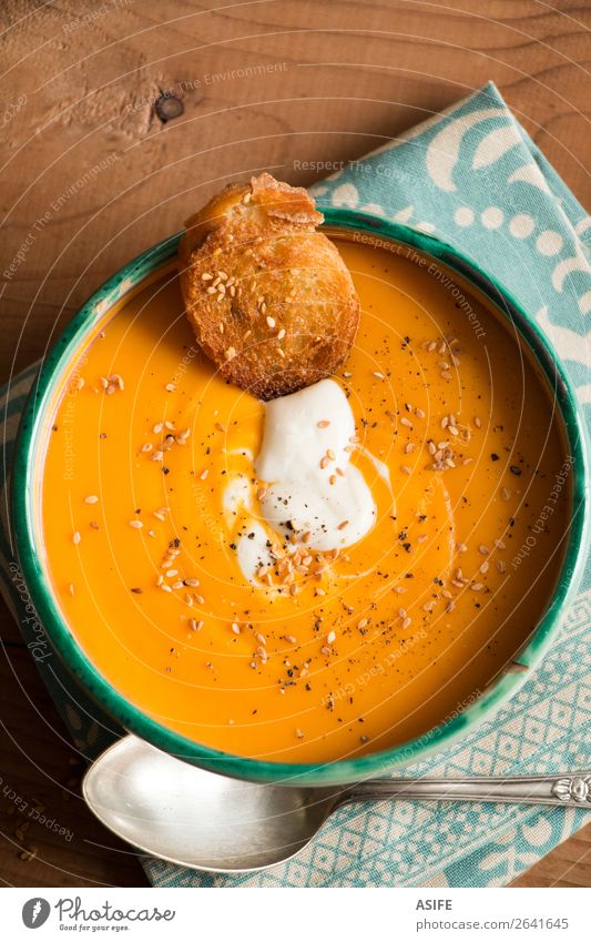 Pumpkin soup with coconut cream, spices and seeds Cheese Vegetable Bread Soup Stew Vegetarian diet Diet Bowl Winter Autumn Wood Orange butternut squash puree