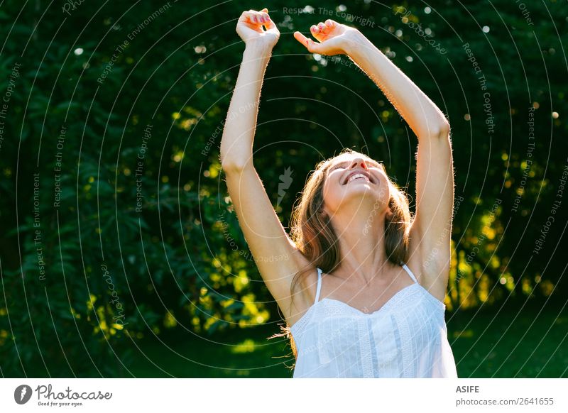 Happy woman enjoying sun Joy Wellness Relaxation Freedom Summer Woman Adults Nature Warmth Tree Park Forest Smiling Laughter Happiness Fresh Cute Green White