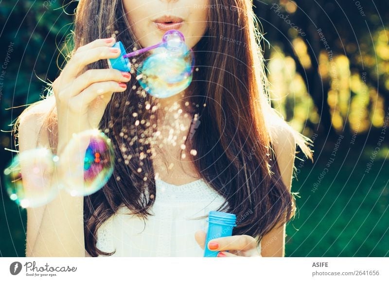 Girl blowing bubbles Joy Happy Beautiful Playing Summer Feasts & Celebrations Human being Woman Adults Lips Nature Warmth Park Dream Happiness Soft Green Soap