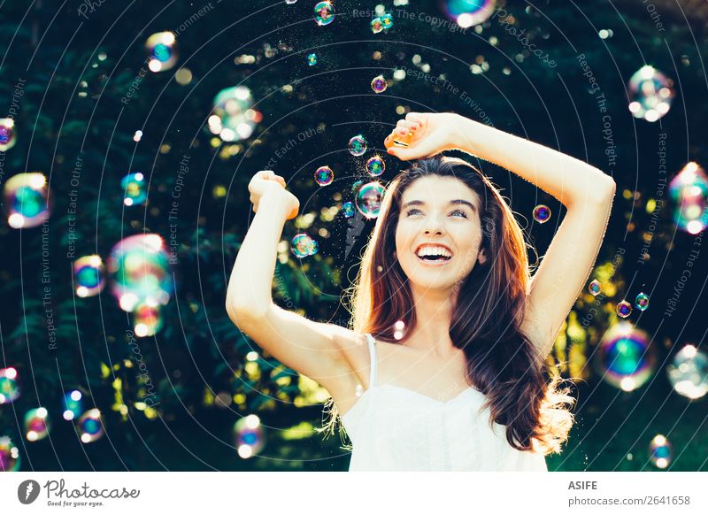 Girl having fun with bubbles Joy Happy Beautiful Playing Summer Feasts & Celebrations Human being Woman Adults Nature Warmth Park Dream Happiness Soft Green