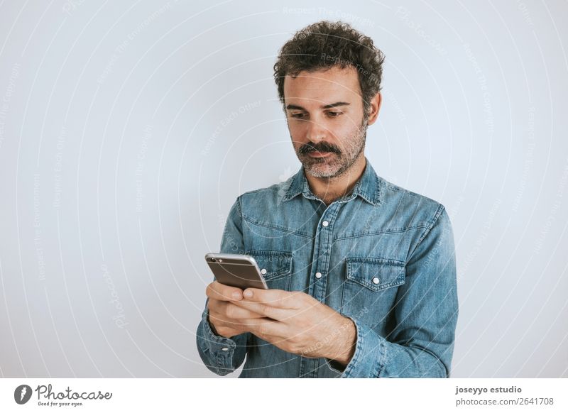 Portrait of a man with mustache using his smartphone. Lifestyle Face Cellphone PDA Human being Adults Fashion Shirt Stand Cool (slang) Hip & trendy