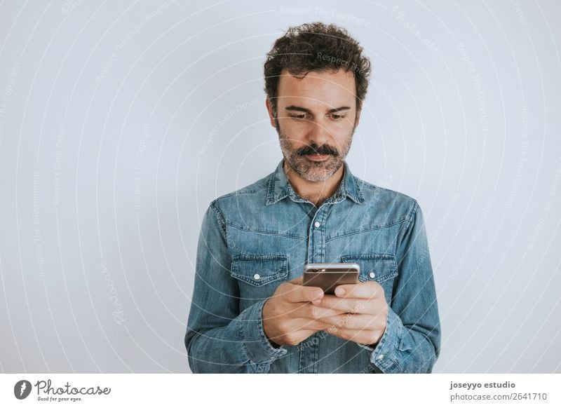 Portrait a man with mustache using his smartphone. Lifestyle Face Cellphone PDA Human being Adults Fashion Shirt Stand Cool (slang) Hip & trendy Self-confident