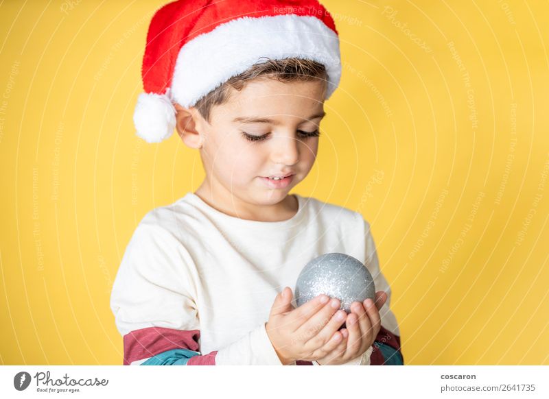 Cute kid with Santa´s hat and a Christmas ball Lifestyle Joy Happy Beautiful Vacation & Travel Winter Decoration Feasts & Celebrations Christmas & Advent