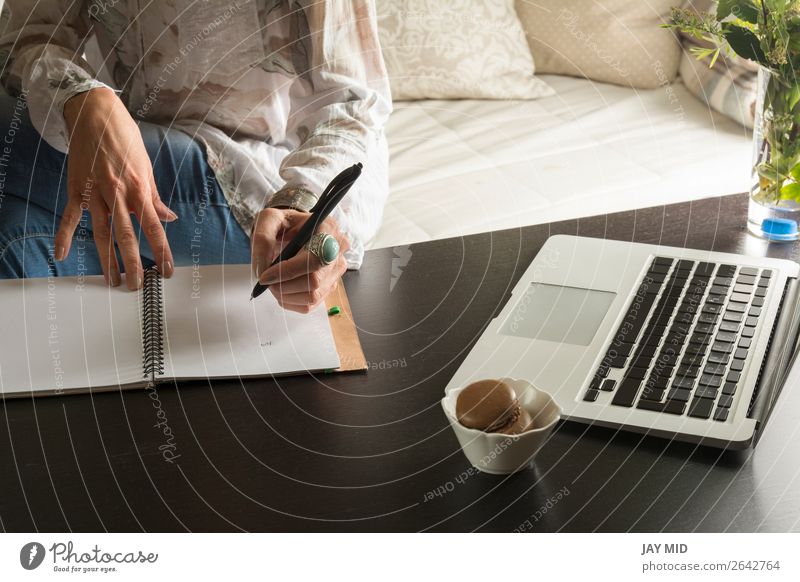 Woman hands writes a pen in a notebook, computer keyboard Lifestyle Work and employment Office Business Computer Technology Human being Adults Hand Paper Pen