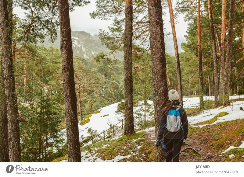 Young woman hiking in white winter forest. Lifestyle concept. Beautiful Vacation & Travel Tourism Trip Adventure Freedom Expedition Winter Snow Winter vacation