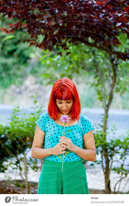 Redhead woman smelling a flower in a park Lifestyle Happy Beautiful Face Wellness Relaxation Fragrance Summer Garden Human being Woman Adults Nature Tree Flower