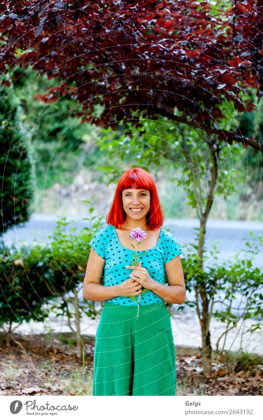 Redhead woman smelling a flower in a park Lifestyle Happy Beautiful Face Wellness Relaxation Fragrance Summer Garden Human being Woman Adults Nature Tree Flower