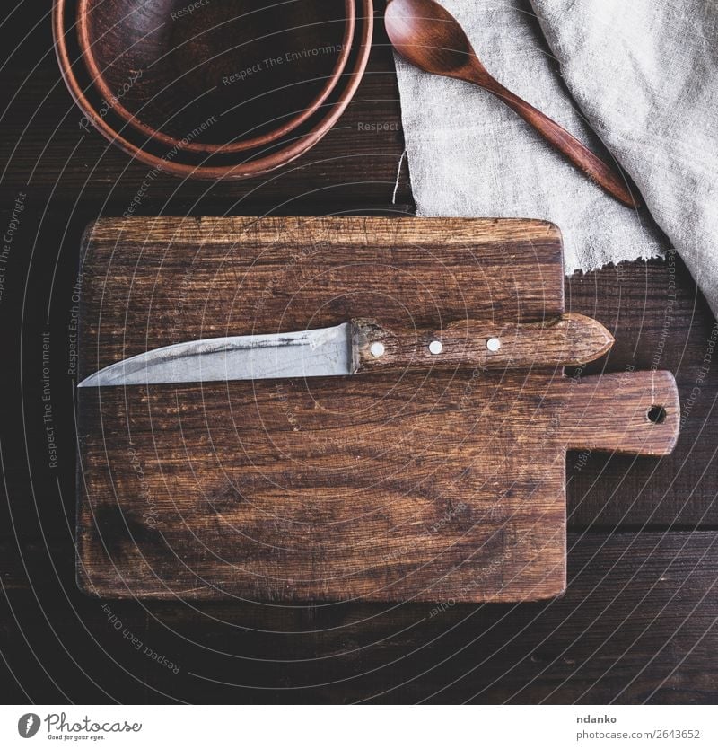 kitchen brown cutting board with handle and knife Plate Bowl Knives Kitchen Nature Wood Old Retro Brown background Blank chopping cook cooking Cut empty food