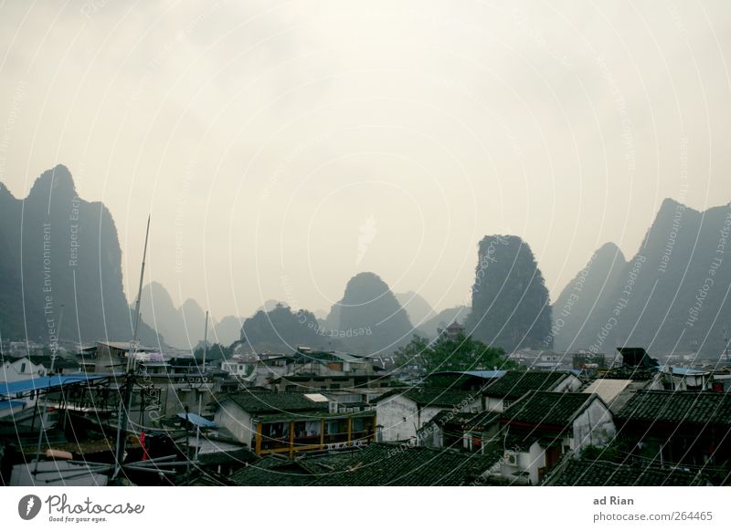 behind seven mountains. Landscape Sky Hill Rock Mountain karst landscape Yangshuo China Guilin Town House (Residential Structure) Roof Haze Fog Colour photo