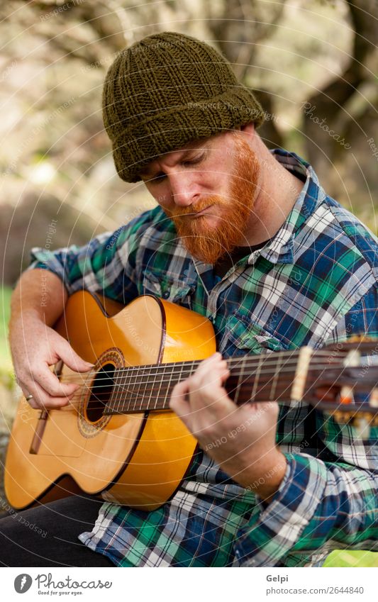 Hipster man with red beard playing a guitar Leisure and hobbies Playing Entertainment Music Human being Man Adults Musician Guitar Nature Red-haired Moustache