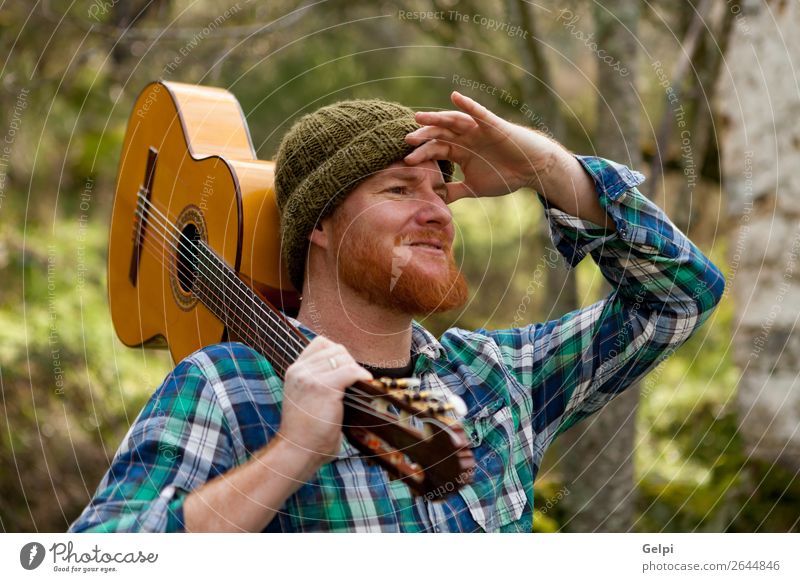 Hipster man holding a guitar and looking Leisure and hobbies Playing House (Residential Structure) Entertainment Music Human being Man Adults Musician Guitar