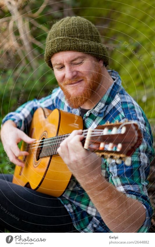 Hipster man with red beard playing a guitar Leisure and hobbies Playing Entertainment Music Human being Man Adults Musician Nature Red-haired Moustache