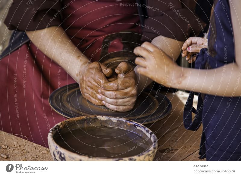 Premium Photo  Potter makes on pottery wheel clay pot and conducts master  class hands of master and child close up