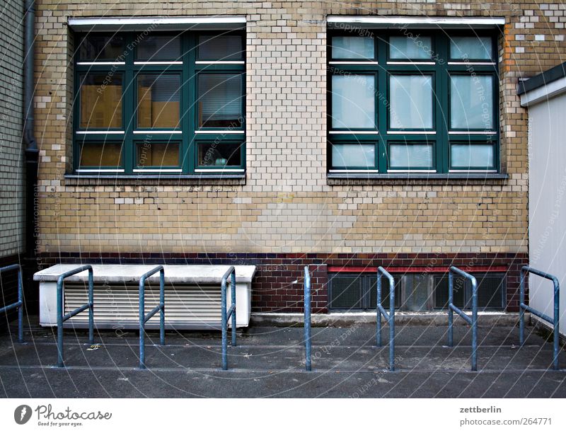 Bicycle stand (empty) Town Manmade structures Building Architecture Wall (barrier) Wall (building) Facade Window Wait Bicycle rack Empty Gloomy Colour photo
