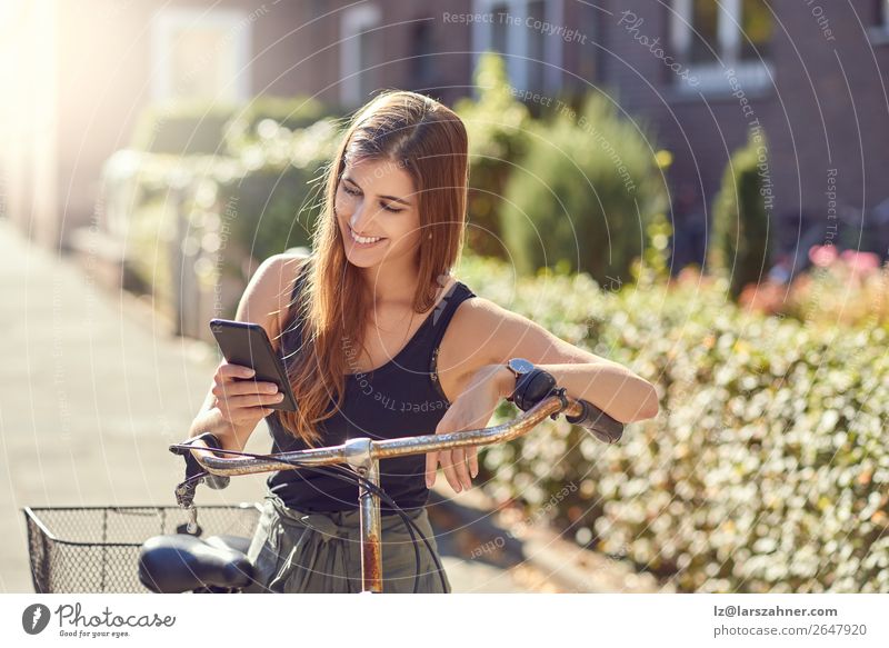 Beautiful woman with bicycle and smartphone Happy Face Summer Business PDA Technology Woman Adults 1 Human being 18 - 30 years Youth (Young adults) Warmth