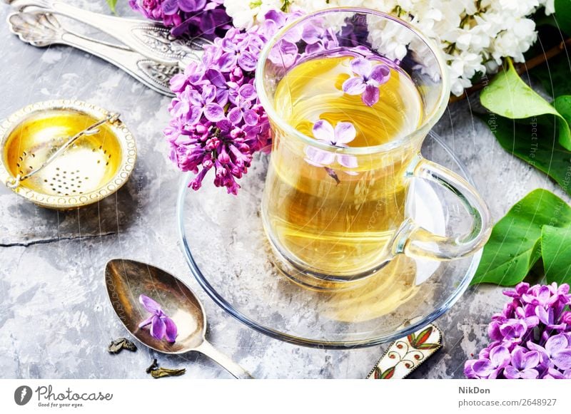 Tea with lilac flavor tea flower cup drink green table pink petal herbal nature leaf fresh spring healthy floral mug blossom glass concept natural bloom aroma