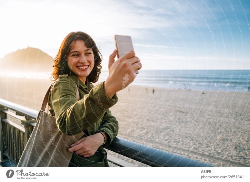 Happy tourist woman taking selfie with her smart phone Beautiful Leisure and hobbies Vacation & Travel Beach Ocean Telephone Cellphone PDA Technology Woman