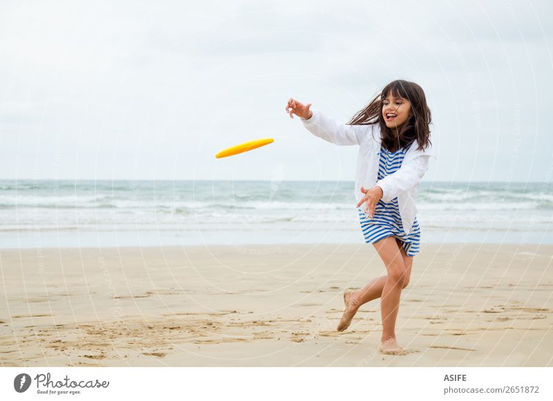 Gril playing frisbee Joy Happy Beautiful Leisure and hobbies Playing Beach Waves Sports Child Sand Clouds Coast Dress Cute Blue Yellow Kid Frisbee action girl