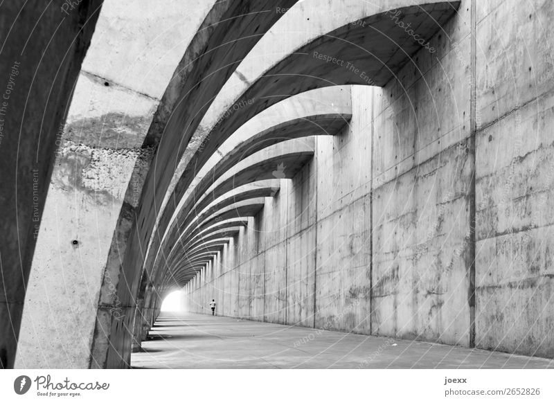 Fair-faced concrete protective wall with curved supporting arches, in which a jogger Wall (building) Contrast Day Exterior shot Subdued colour Man White Black