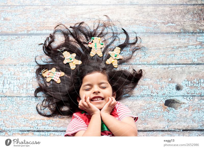 Cute cheerful smiling girl with decorated Christmas hair Style Joy Happy Beautiful Hair and hairstyles Face Winter Decoration Feasts & Celebrations