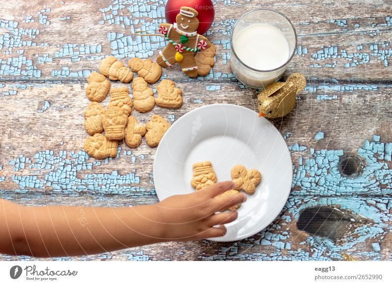 Cute little girl is playing with Santa's cookies and milk Eating Lifestyle Joy Happy Beautiful Playing Winter Table Feasts & Celebrations Christmas & Advent