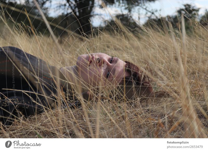 Young woman lying on a dried summer meadow Feminine Youth (Young adults) Head Face 1 Observe Relaxation Dream Sadness naturally Rebellious pretty Emotions Calm