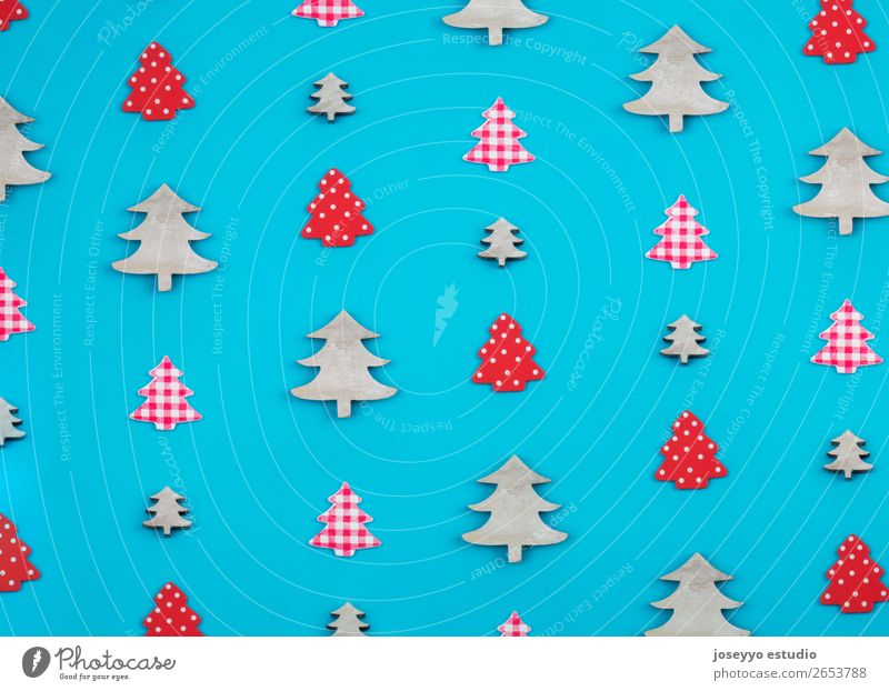 Christmas pattern made of christmas trees. Design Winter Decoration Feasts & Celebrations Craft (trade) Paper Simple Above Blue Red White Creativity background
