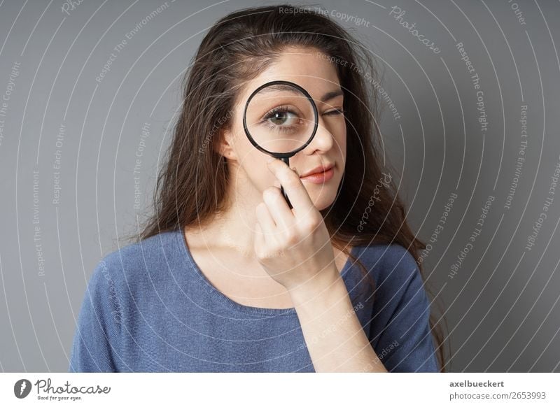 young woman looks through magnifying glass Lifestyle Business Human being Feminine Young woman Youth (Young adults) Woman Adults 1 18 - 30 years Brunette