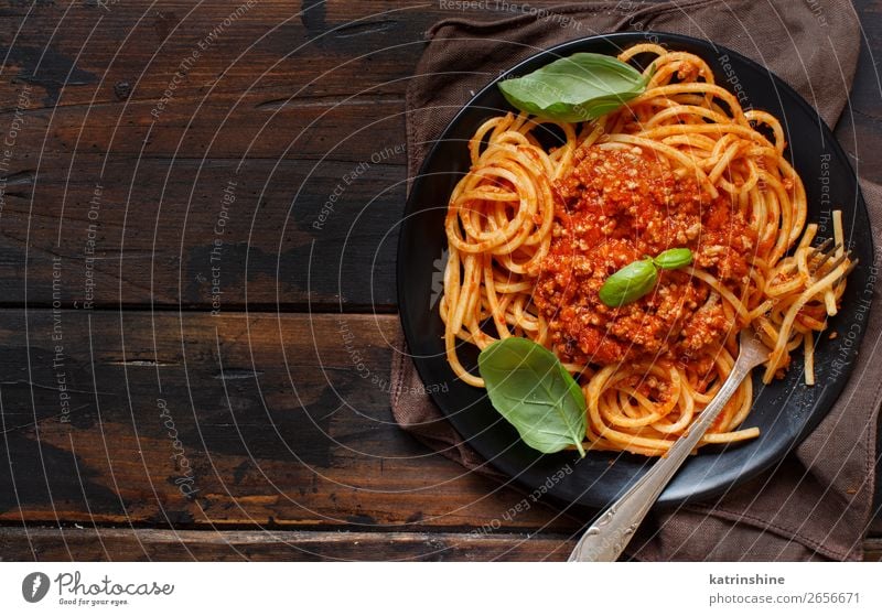 Spaghetti pasta with bolognese sauce Meat Cheese Herbs and spices Lunch Dinner Plate Fork Wood Bright Above Tradition Basil Beef Bolognese Cooking Dish food