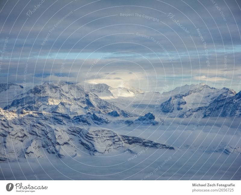 Amazing aerial view of misty swiss alps and clouds Vacation & Travel Winter Snow Mountain Nature Landscape Sky Clouds Horizon Weather Fog Rock Alps Peak