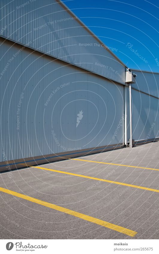 parking space Deserted Building Wall (barrier) Wall (building) Roof Stone Concrete Blue Yellow Gray Parking lot Hall Empty Colour photo Exterior shot