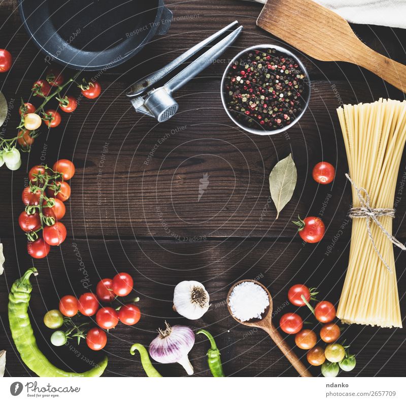 pasta raw tied up with rope Vegetable Dough Baked goods Herbs and spices Pan Spoon Table Kitchen Wood Line Fresh Large Long Above Brown Yellow Red Black Colour