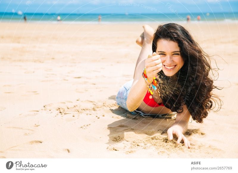 Happy young woman enjoying the beach Joy Beautiful Relaxation Playing Vacation & Travel Summer Sun Sunbathing Beach Ocean Woman Adults Hand Nature Sand Wind