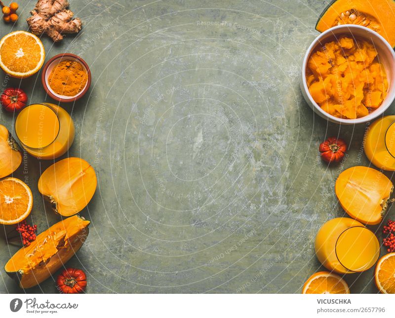 Orange color smoothie ingredients background for cold season with  pumpkin, orange fruits, ginger, turmeric and persimmon fruits , top view, frame, copy space. Healthy mood and energy smoothie drinks