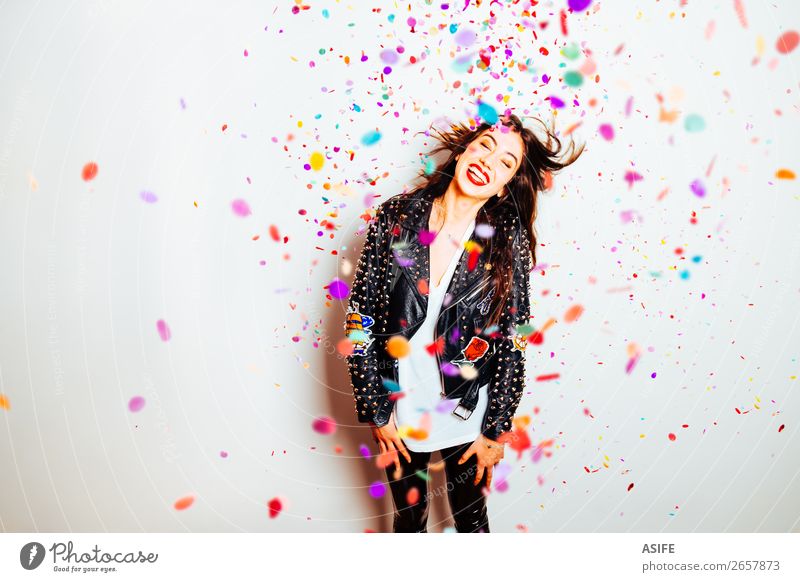 Happy young and beatiful woman with fashion leather jacket enjoying the party with confetti Joy Beautiful Make-up Lipstick Rouge Feasts & Celebrations
