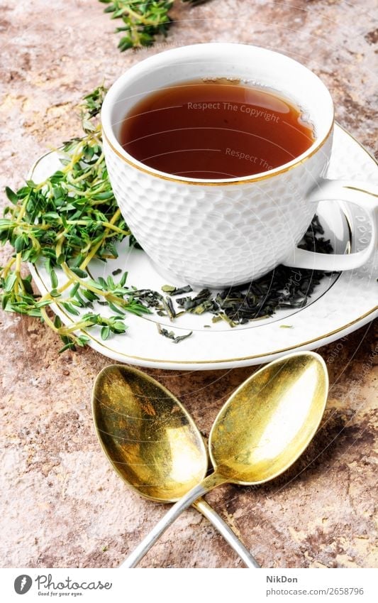 Herbal tea with thyme herbal healthy drink green leaf cup beverage natural flower plant glass organic medicine fresh aroma breakfast petal medicinal spoon