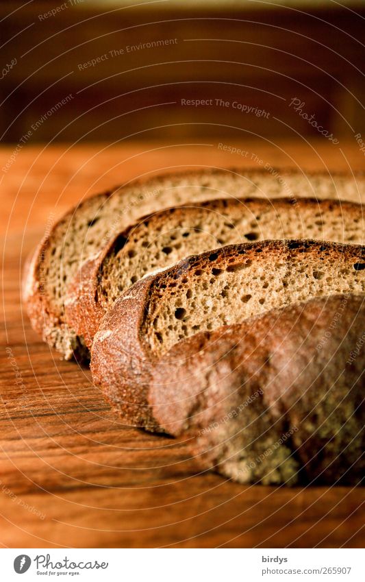 Slices of gray bread on a wooden board. sliced bread Bread Baked goods slices of bread Food Dough Organic produce Delicious Brown Appetite snack